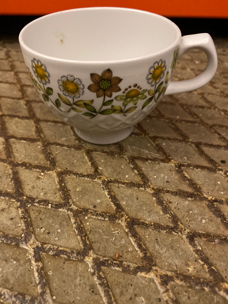 Textured teacup with sunflower pattern