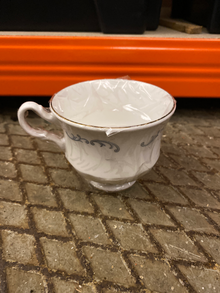 White teacup with grey-blue pattern