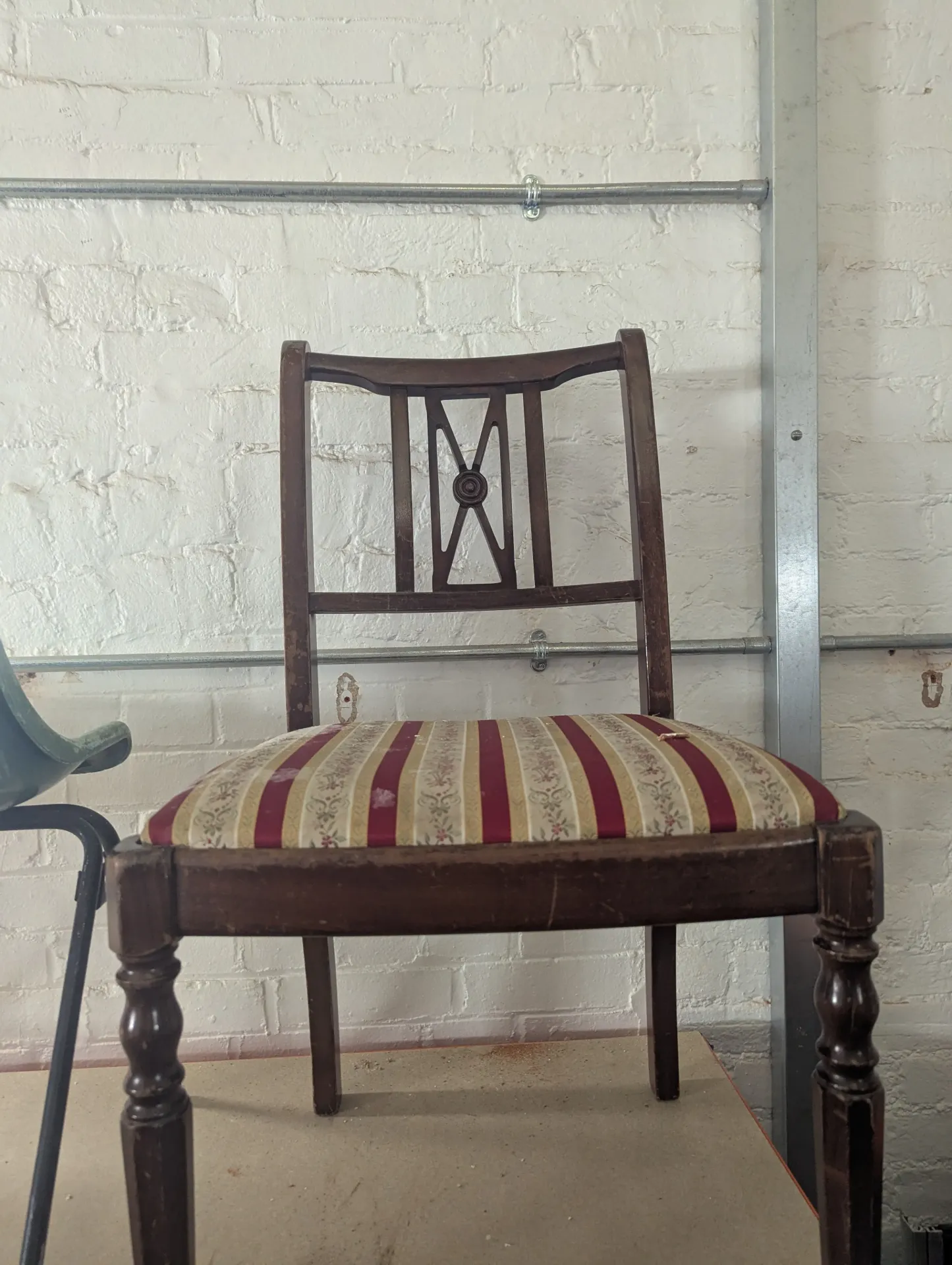 Brown chair with striped cushion