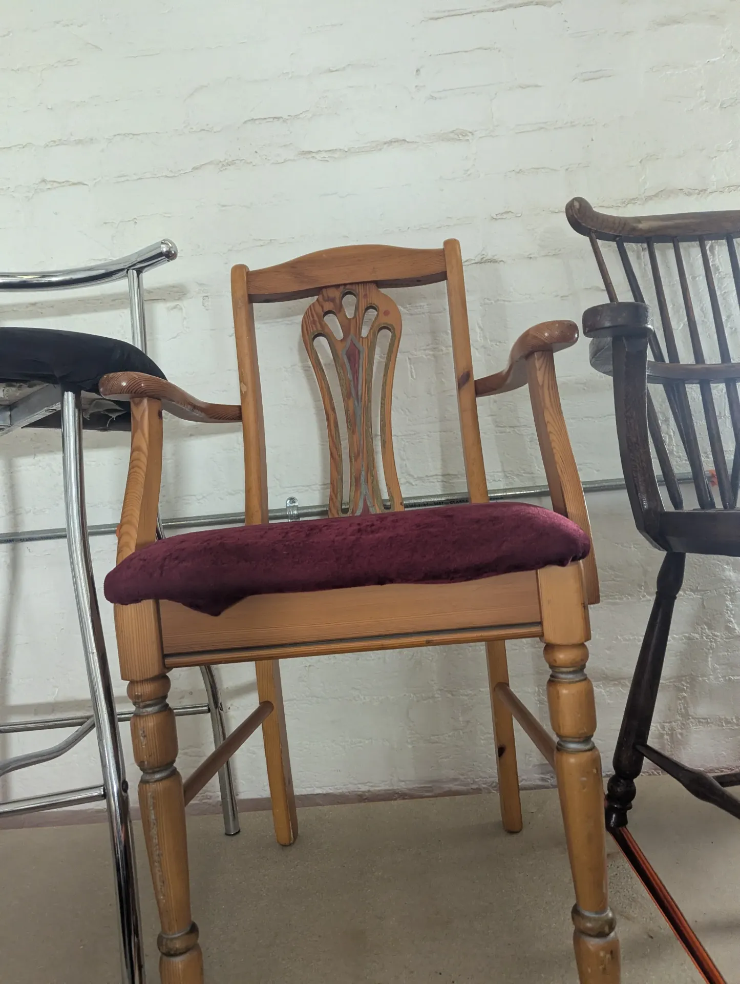 Brown wooden armchair with red seat