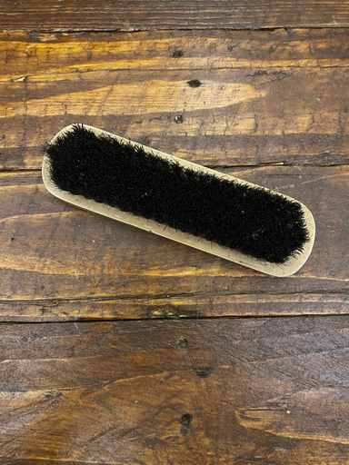 Small handheld brush (black bristles)